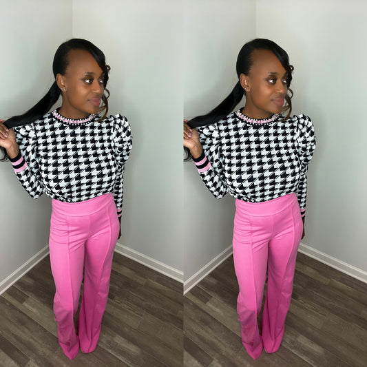 Forever Galore wearing a classy houndstooth sweater with pearls and pink details 